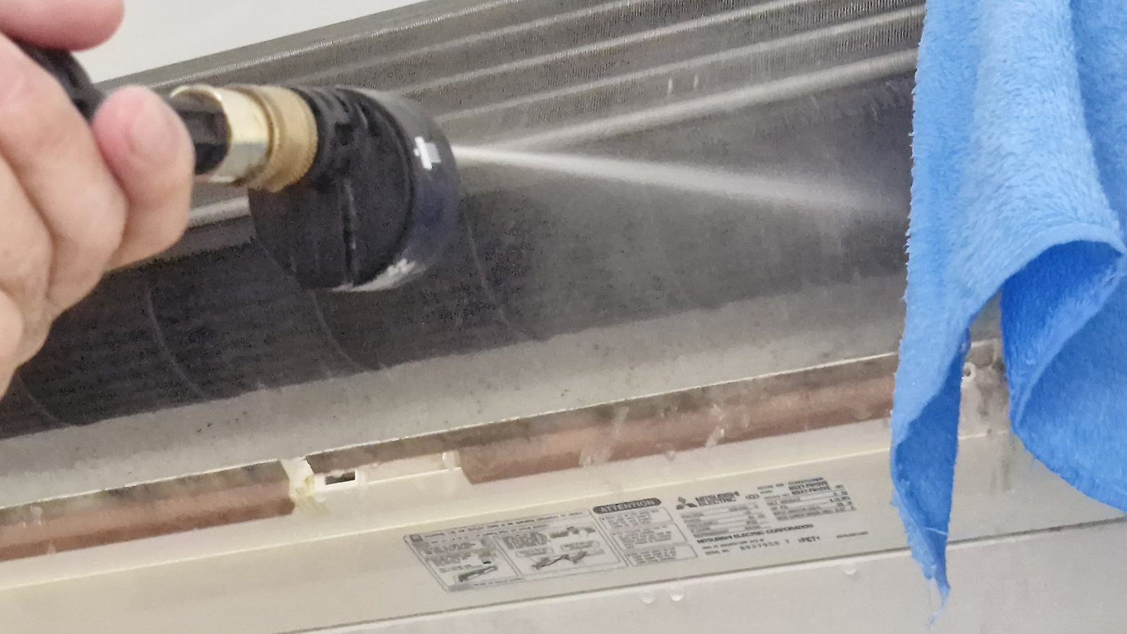 Pressure-washing a blackened evaporator coil during a deep clean